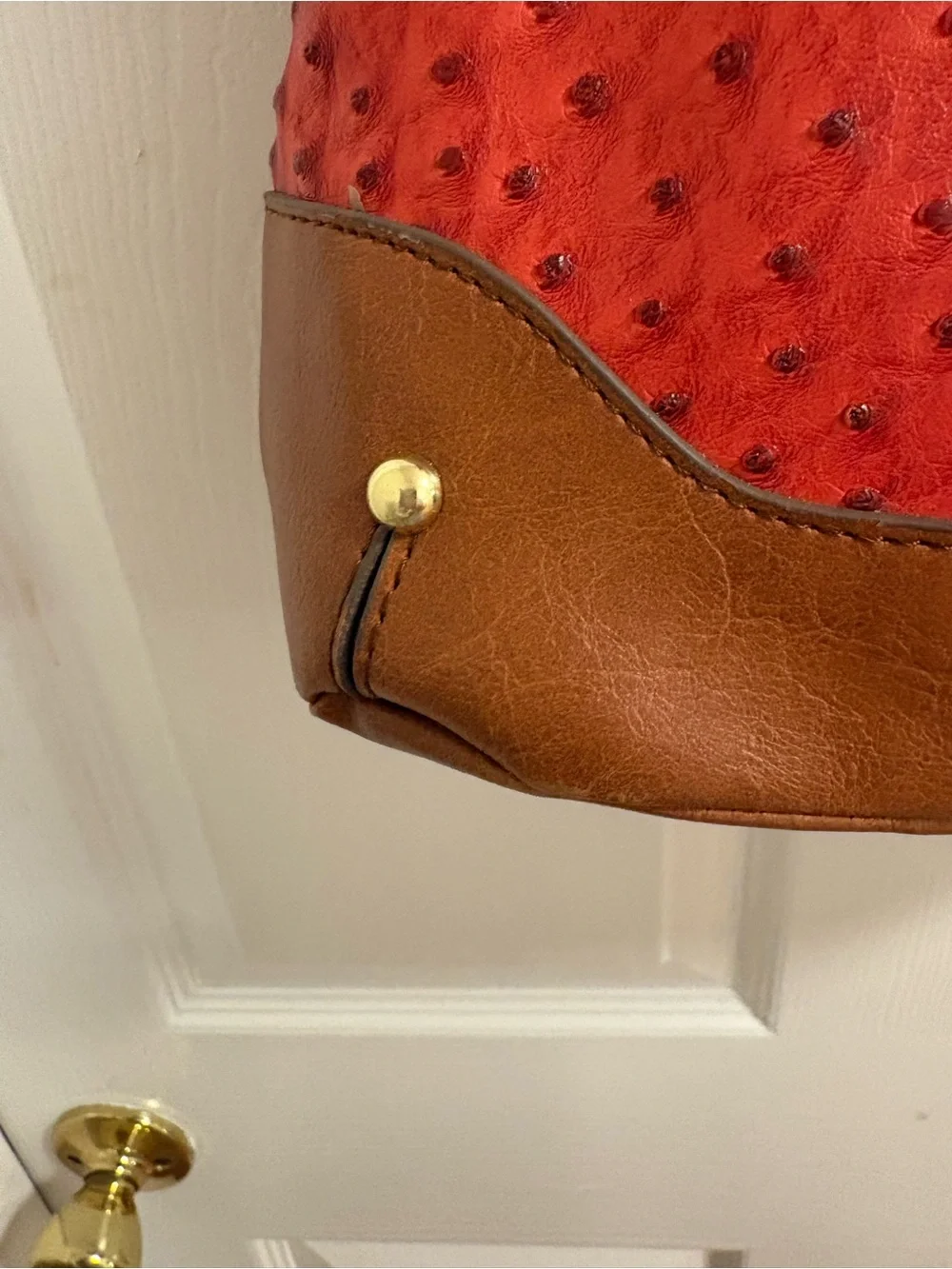 London Fog satchel features a distinctive red ostrich print and lock& key
